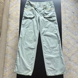 Wide leg green pants with interesting pocket and satin trim detail